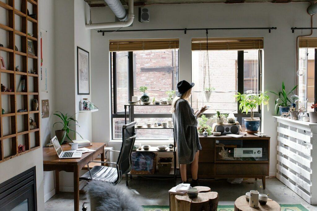Woman in attractive, eclectic home office.