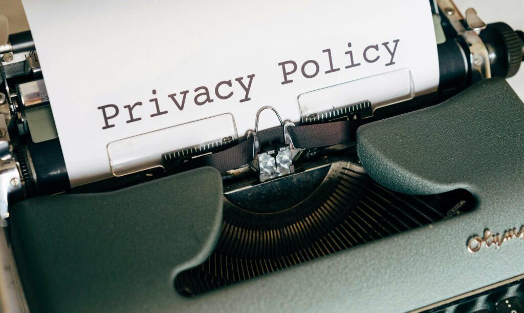 Typewriter with a sheet of paper in it on which "Privacy Policy" is typed.
