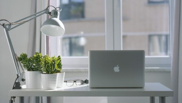 Office desk with lamp and natural light from a window